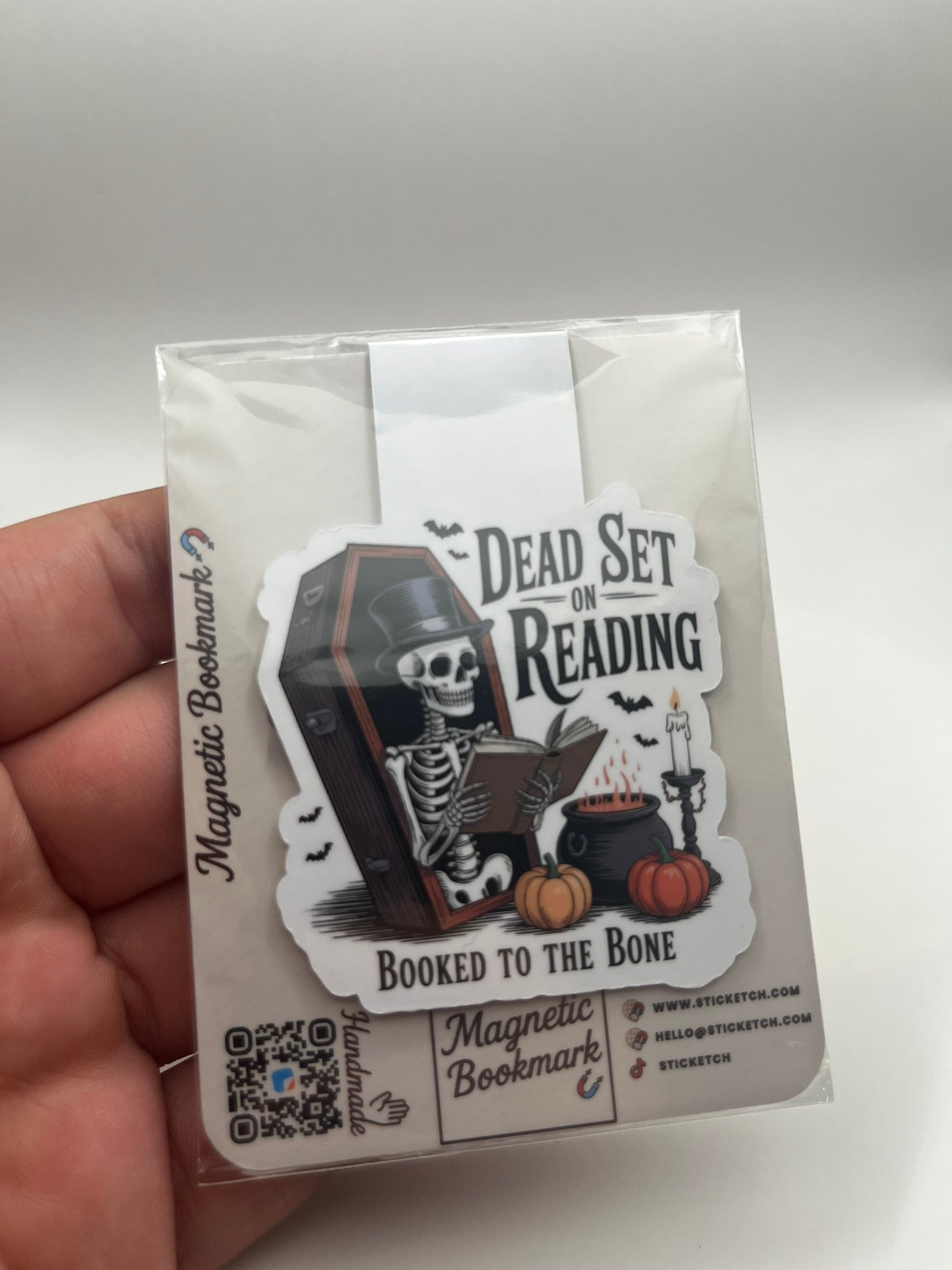 Magnetic bookmark packaging with skeleton design and text on a white background
