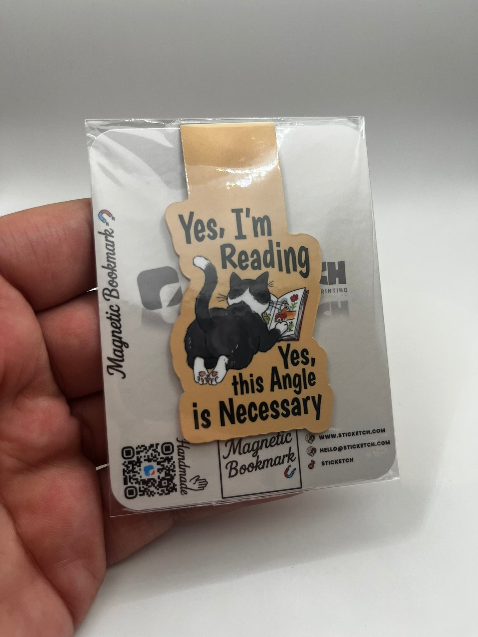 Cat reading on magnetic bookmark