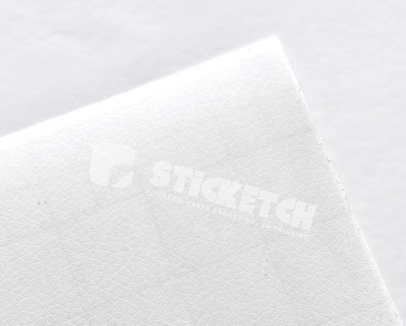 Textured white surface with 'Fiskars' branding and 'Leather Sticker Finish' label on a light gray background.